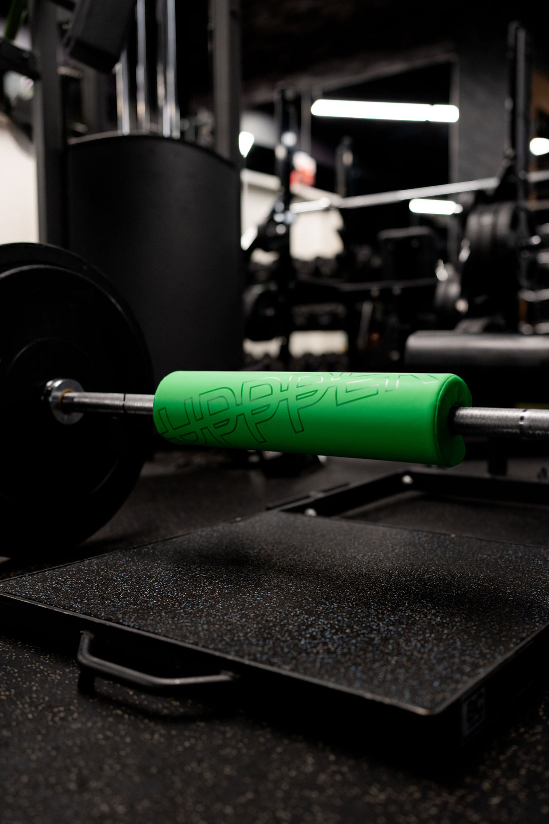 uppper neon green barbell pad on barbell