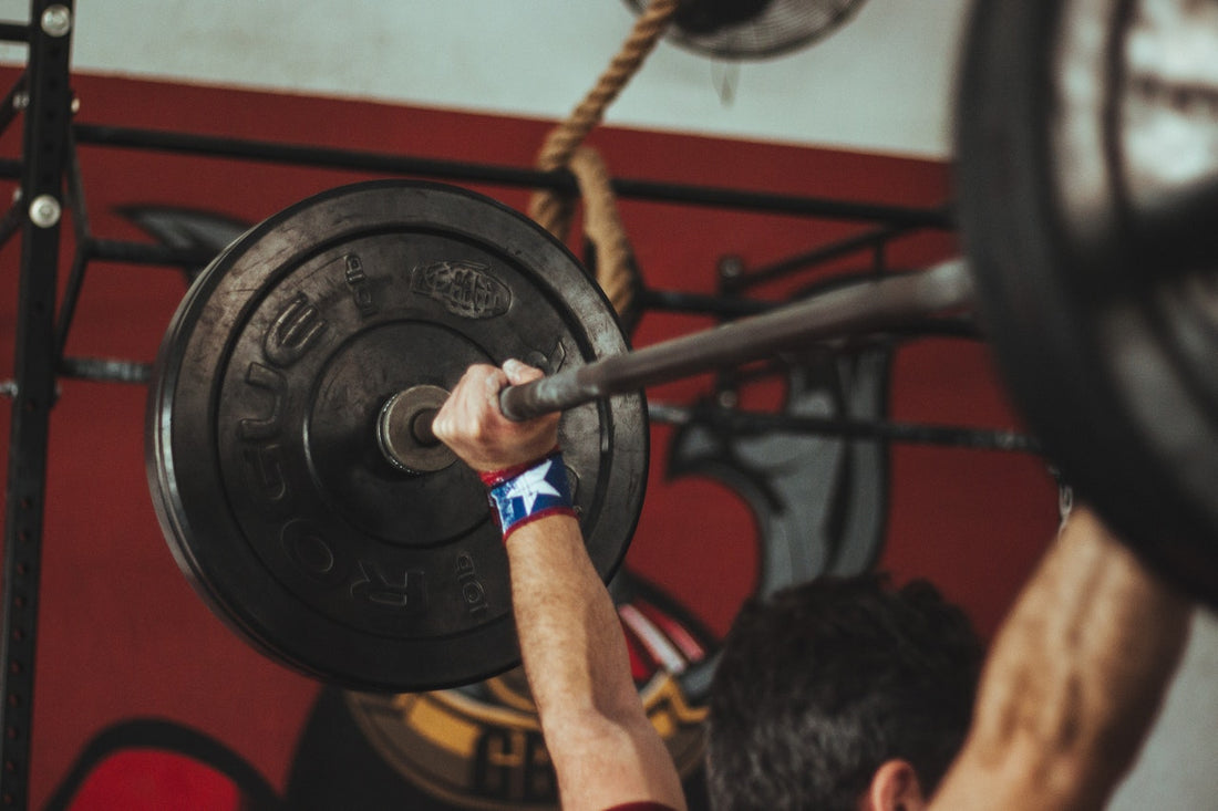 man doing barbell shoulder press